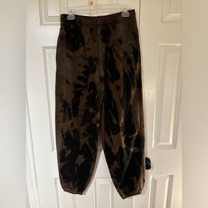 Black and bleach stained sweatpants